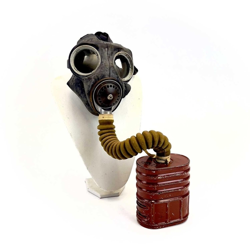 95 - A WWII British No.4 III gas mask. Together with a steel helmet and WWII webbing belt and harness.