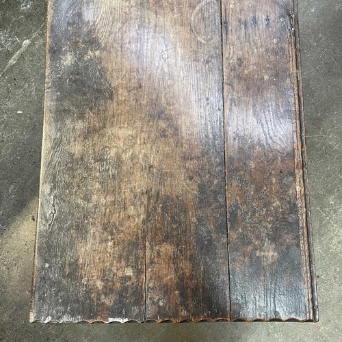 10 - A 17th century boarded oak coffer, probably West Country. The plank top and sides with scalloped edg... 