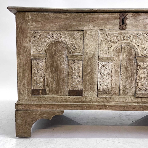 16 - An 18th century oak coffer. The three panel front with applied arched mouldings, height 62cm width 1... 