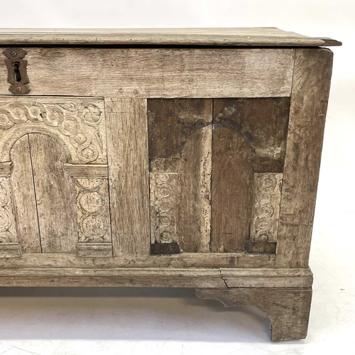 16 - An 18th century oak coffer. The three panel front with applied arched mouldings, height 62cm width 1... 