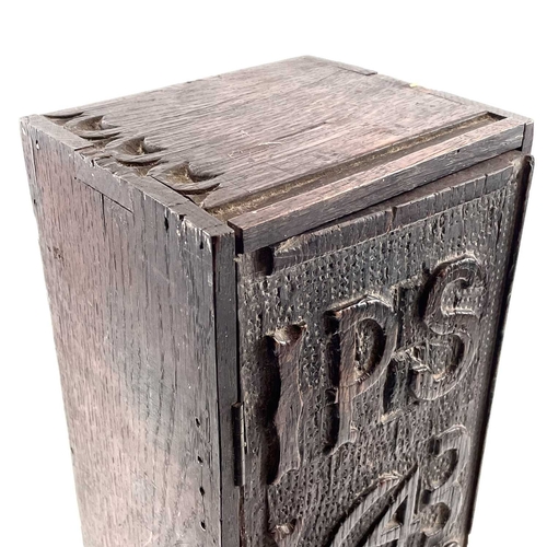 21 - An oak candle box. 19th century, the earlier panel door dated 1643 and initialled IPS RPE, height 51... 