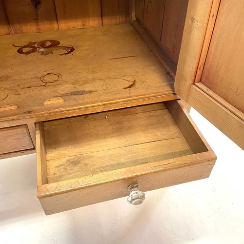 28 - A Victorian small pine kitchen dresser. The base fitted two panel doors above two drawers, on square... 