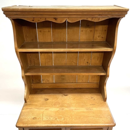 28 - A Victorian small pine kitchen dresser. The base fitted two panel doors above two drawers, on square... 