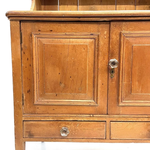 28 - A Victorian small pine kitchen dresser. The base fitted two panel doors above two drawers, on square... 