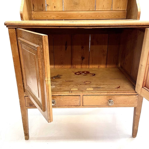 28 - A Victorian small pine kitchen dresser. The base fitted two panel doors above two drawers, on square... 