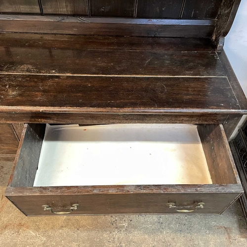 5 - A late Victorian oak dresser. The plate rack fitted two carved cupboard doors, the base with two dra... 