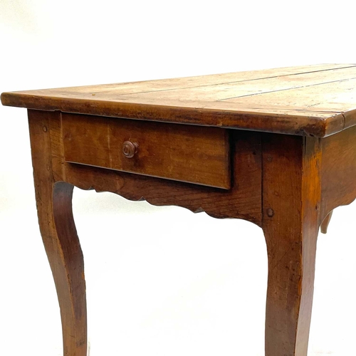 35 - A French fruitwood farmhouse kitchen table. Circa 1820, with cleated three plank top, shaped frieze ... 