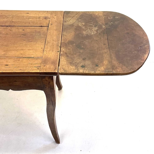 35 - A French fruitwood farmhouse kitchen table. Circa 1820, with cleated three plank top, shaped frieze ... 