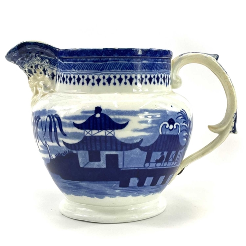 45 - A blue and white Chinoiserie printed porcellanous jug, With lion mask spout, circa 1840, height 15.5... 