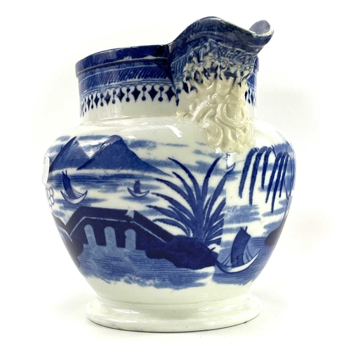 45 - A blue and white Chinoiserie printed porcellanous jug, With lion mask spout, circa 1840, height 15.5... 