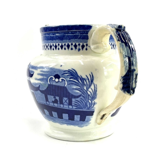 45 - A blue and white Chinoiserie printed porcellanous jug, With lion mask spout, circa 1840, height 15.5... 