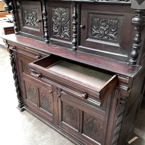 50 - An oak court cupboard, partly 17th century. The carved frieze with initials C.R.B above two doors fl... 