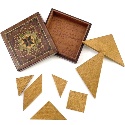 51 - A Tunbridge ware Tangram small puzzle box. With inlaid lid and labelled to the underside for T Barto... 