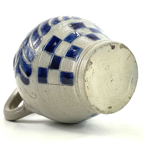 58 - A saltglaze jug with blue incised feather decoration and chequered borders. Circa 1730, with moulded... 