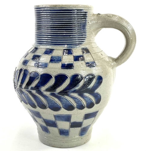 58 - A saltglaze jug with blue incised feather decoration and chequered borders. Circa 1730, with moulded... 