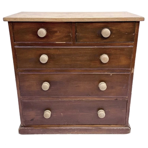 61 - A late Victorian pine chest. With scrub top above two short and three long drawers with turned woode... 