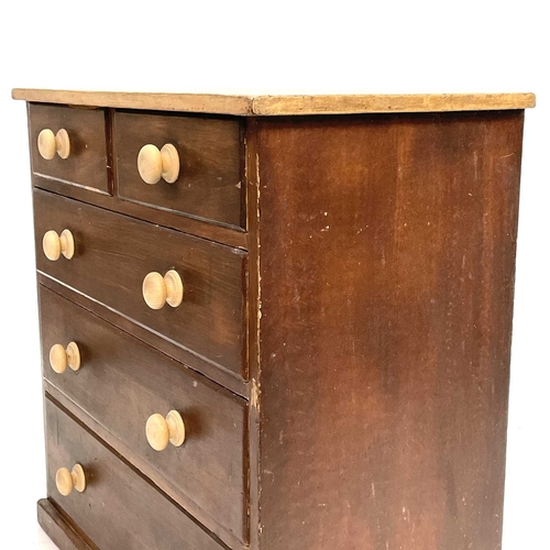 61 - A late Victorian pine chest. With scrub top above two short and three long drawers with turned woode... 