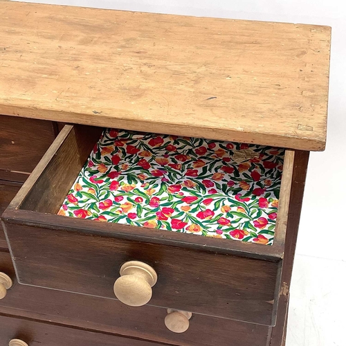 61 - A late Victorian pine chest. With scrub top above two short and three long drawers with turned woode... 