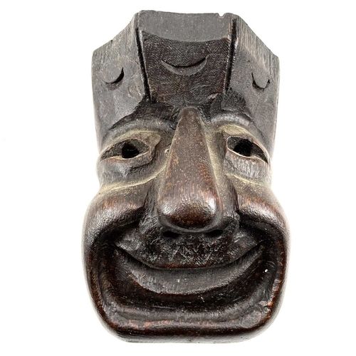 258 - An oak carved mask of a smiling man. Together with various wood carved items and pewter.