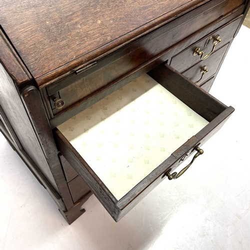 260 - A George II oak bureau, the fall front opening to reveal a fitted interior. Above two short and two ... 