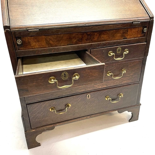 260 - A George II oak bureau, the fall front opening to reveal a fitted interior. Above two short and two ... 