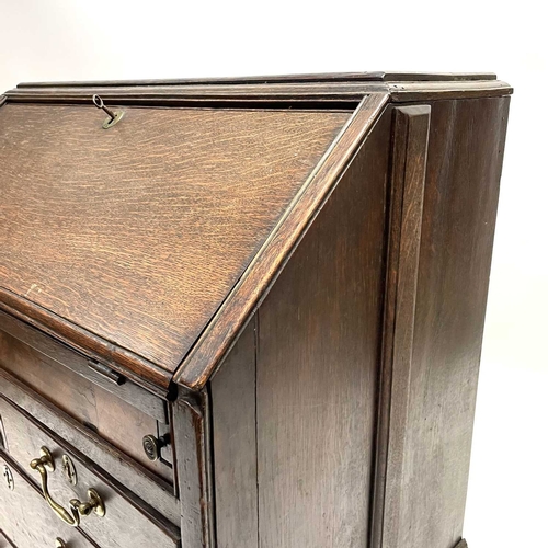 260 - A George II oak bureau, the fall front opening to reveal a fitted interior. Above two short and two ... 