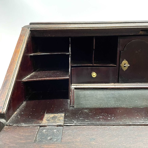 260 - A George II oak bureau, the fall front opening to reveal a fitted interior. Above two short and two ... 