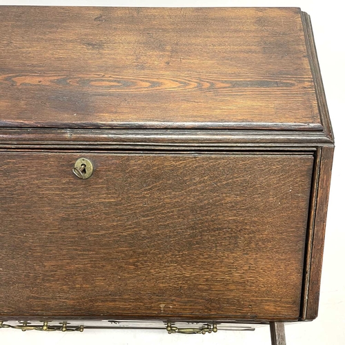 260 - A George II oak bureau, the fall front opening to reveal a fitted interior. Above two short and two ... 