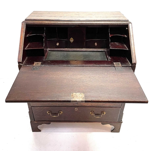 260 - A George II oak bureau, the fall front opening to reveal a fitted interior. Above two short and two ... 