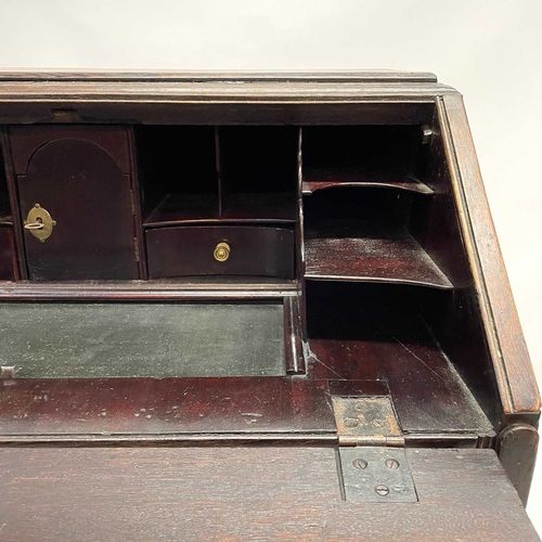 260 - A George II oak bureau, the fall front opening to reveal a fitted interior. Above two short and two ... 