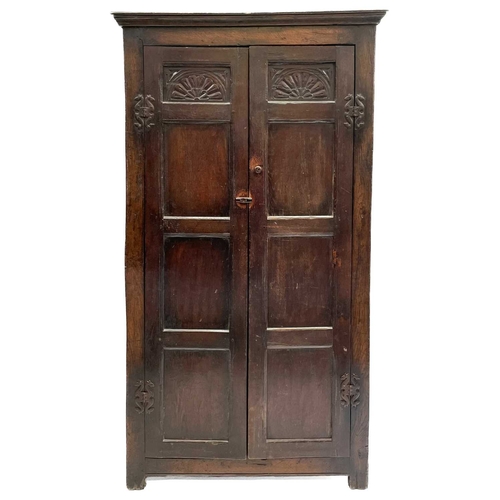 261 - A late 19th or early 20th century oak wardrobe with parts constructed from earlier elements. The twi... 