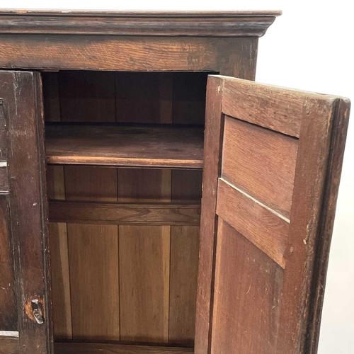 261 - A late 19th or early 20th century oak wardrobe with parts constructed from earlier elements. The twi... 