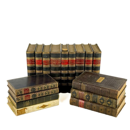 24 - Bindings. A handsome set of nine works by Charles Dickens, half black calf with marbled boards and c... 