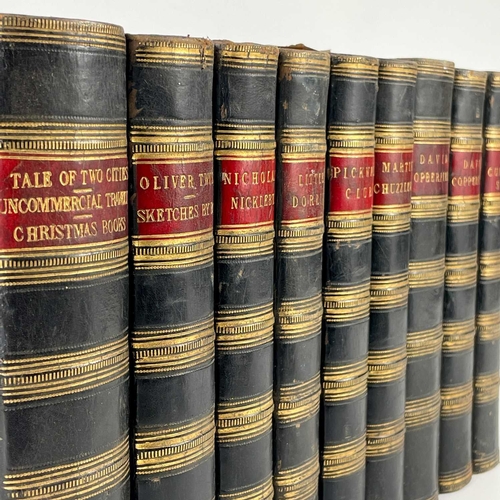 24 - Bindings. A handsome set of nine works by Charles Dickens, half black calf with marbled boards and c... 