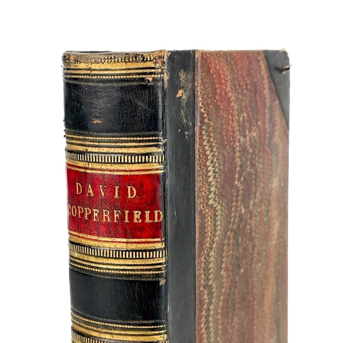 24 - Bindings. A handsome set of nine works by Charles Dickens, half black calf with marbled boards and c... 