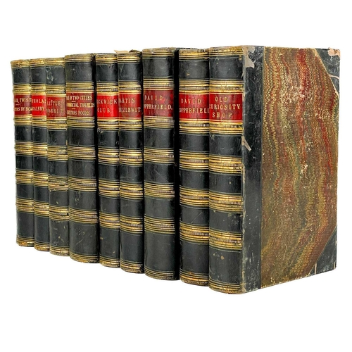 24 - Bindings. A handsome set of nine works by Charles Dickens, half black calf with marbled boards and c... 