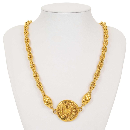 122 - A Chanel 1970's gold-tone medallion necklace. The two medallions with cast inscription CHANEL FRANCE... 