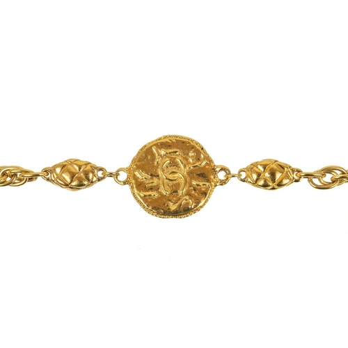 122 - A Chanel 1970's gold-tone medallion necklace. The two medallions with cast inscription CHANEL FRANCE... 