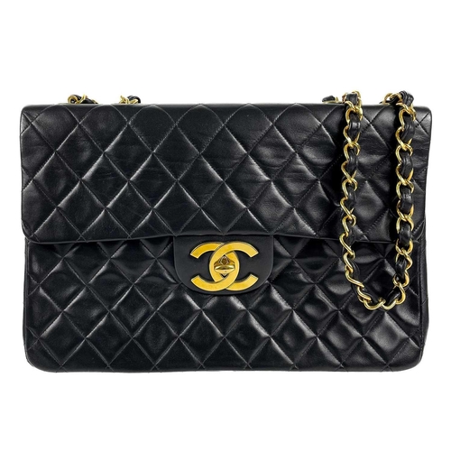 125A - A Chanel black lambskin jumbo maxi single flap bag. Circa 1994-1996, with gold-tone hardware, burgun... 