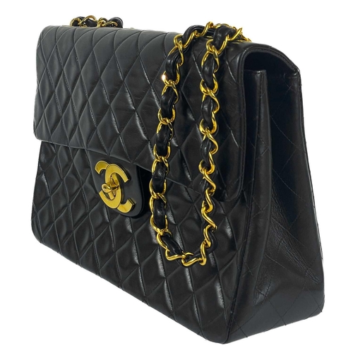 125A - A Chanel black lambskin jumbo maxi single flap bag. Circa 1994-1996, with gold-tone hardware, burgun... 