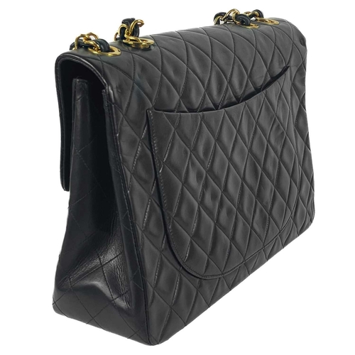 125A - A Chanel black lambskin jumbo maxi single flap bag. Circa 1994-1996, with gold-tone hardware, burgun... 