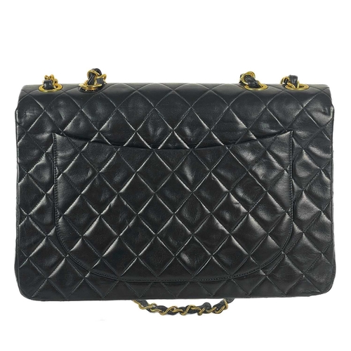 125A - A Chanel black lambskin jumbo maxi single flap bag. Circa 1994-1996, with gold-tone hardware, burgun... 