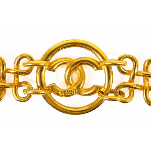 129 - A Chanel CC three medallion bracelet. Circa 1993, gold tone, stamped CHANEL MADE IN FRANCE 93 P to o... 