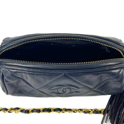 130A - A Chanel blue lambskin quilted navy blue leather barrel camera bag. Circa 1986-1988, gold-tone hardw... 