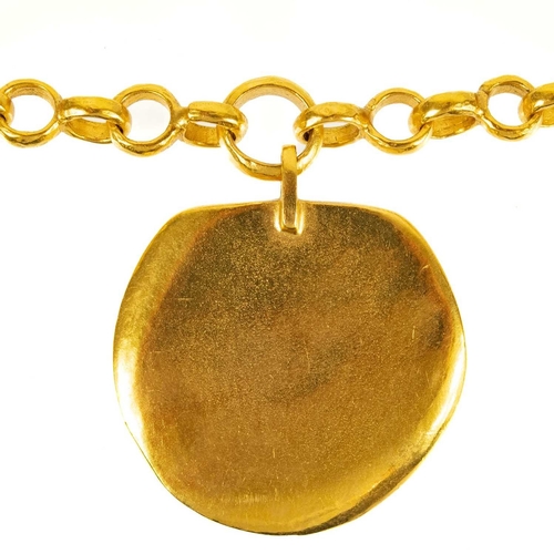 140 - A Chanel gold tone medallion pendant necklace. The CC cast pendant with matte finish, the necklace w... 