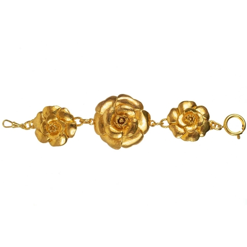 144 - A Chanel 1980's gold tone triple flower head bracelet. Stamped to circular plaque on the back CHANEL... 