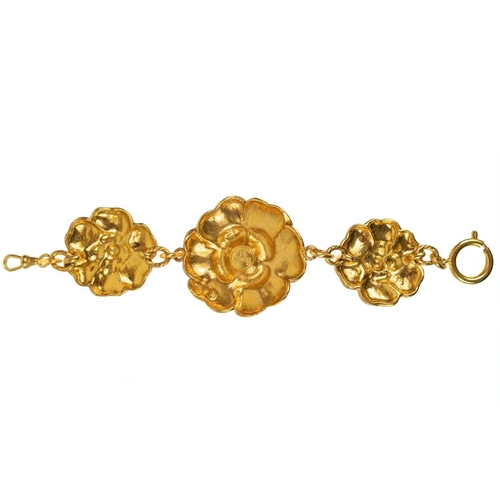 144 - A Chanel 1980's gold tone triple flower head bracelet. Stamped to circular plaque on the back CHANEL... 