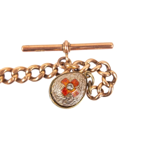 41 - A 9ct rose gold graduated curb link Albert watch chain. With applied gold plated enamel egg shaped f... 