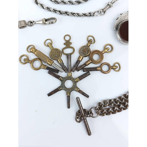 53 - A collection of base metal Albert watch chains, winding keys and a silver swivel fob. Etc.