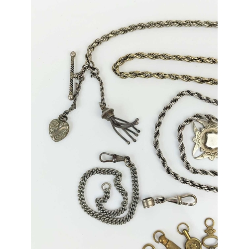 53 - A collection of base metal Albert watch chains, winding keys and a silver swivel fob. Etc.